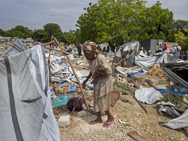 A woman gathers her belongings 