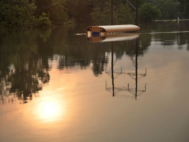 An old school bus sits in floodwaters 