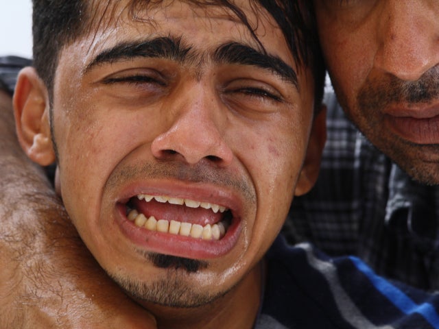 Family member cries out at a funeral 