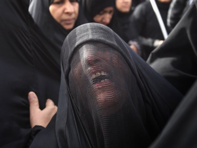Family members grieve during the funeral procession 