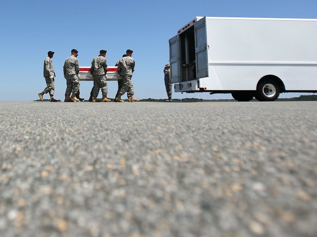 A U.S. Army carry team moves the transfer case of soldier 