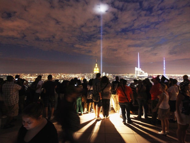 People view the Tribute in Light from the Top of the Rock 