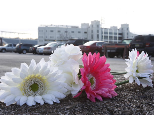 Flowers lie on the ground as a memorial at Virginia Tech 