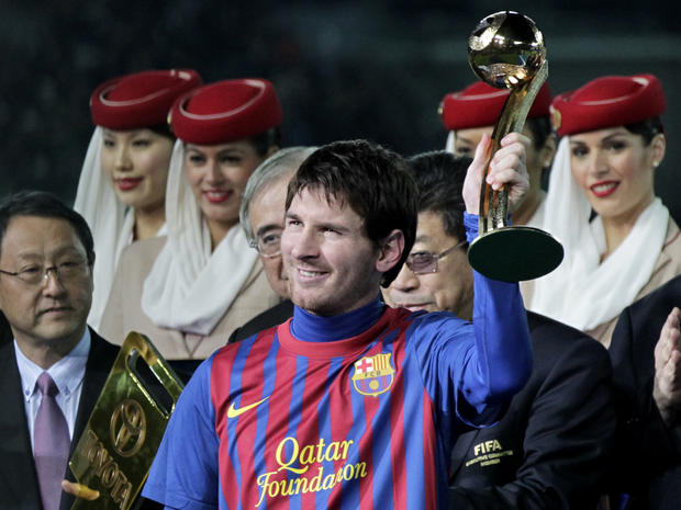 Lionel Messi holds the Golden Ball trophy  