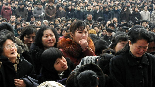 North Koreans grieve as they visit a portrait of the late leader Kim Jong Il at Kim Il Sung Square in Pyongyang, North Korea, Dec. 21, 2011. 
