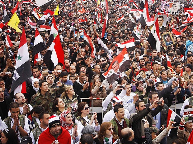 Pro-regime protesters chant slogans during a rally at Umayyad Square in Damascus, Syria, Dec. 21, 2011. 