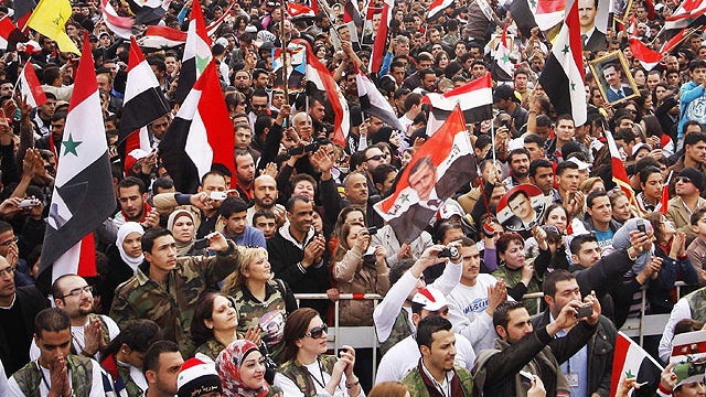 Pro-regime protesters chant slogans during a rally at Umayyad Square in Damascus, Syria, Dec. 21, 2011.  