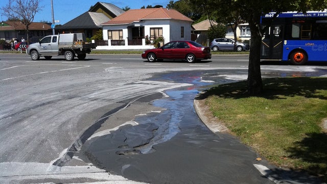 Liquefaction is seen seeping out of the ground after a 5.8-magnitude quake struck 16 miles north of Christchurch 