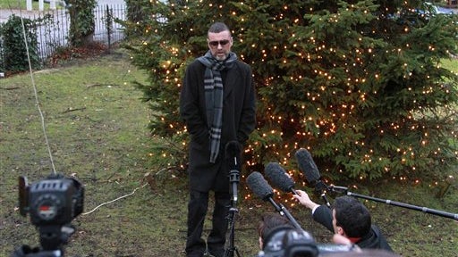 After being hospitalized for pneumonia, George Michael arrives back at his home in London on Dec. 23, 2011. 