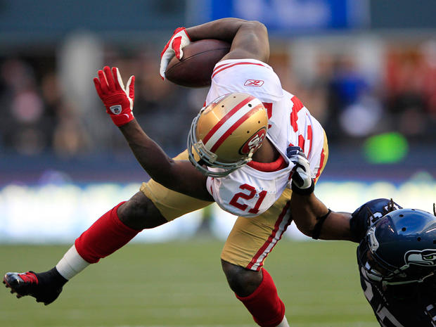 Frank Gore is grabbed by Richard Sherman 