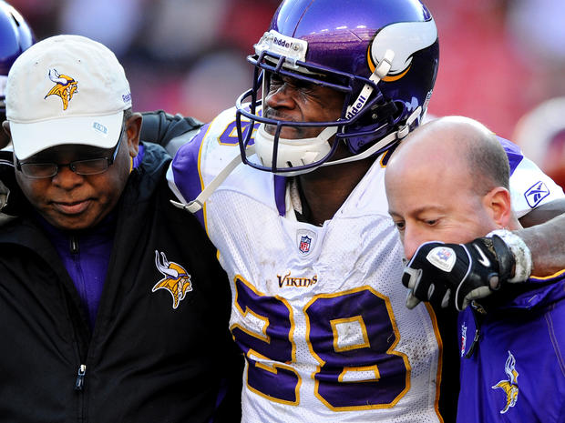 Adrian Peterson is helped off the field 