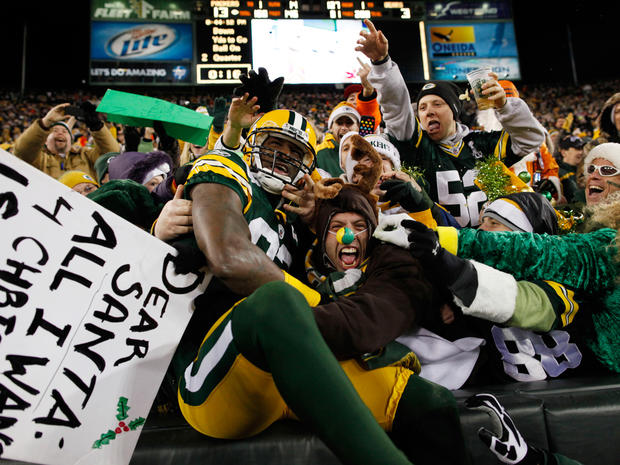 James Jones celebrates with fans after catching a touchdown pass  