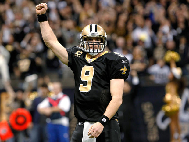 Drew Brees celebrates after throwing a touchdown pass and breaking the NFL single-season record  