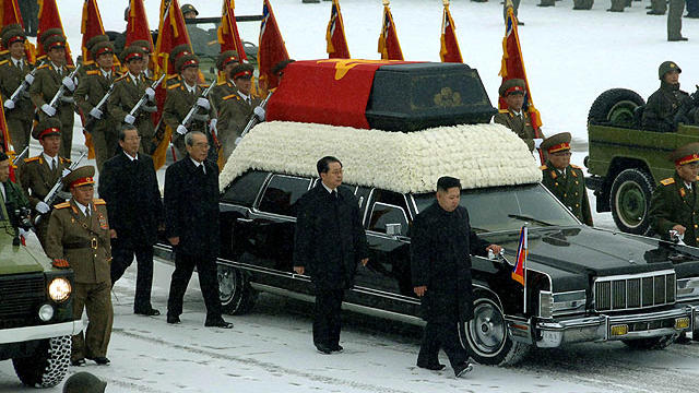 This handout picture taken by North Korea's official Korean Central News Agency (KCNA) on December 28, 2011 shows Kim Jong-Un, center right, and Jang Song-Thaek, center, besides the convoy carrying the body of his father and late leader Kim Jong-Il at Kum 