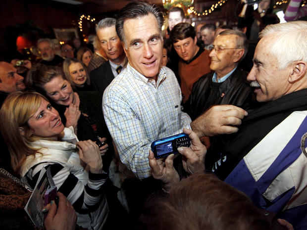 Former Massachusetts Gov. Mitt Romney makes his way through a crowd during a campaign stop at Old Salt Restaurant in Hampton, N.H., Dec. 31, 2011. 