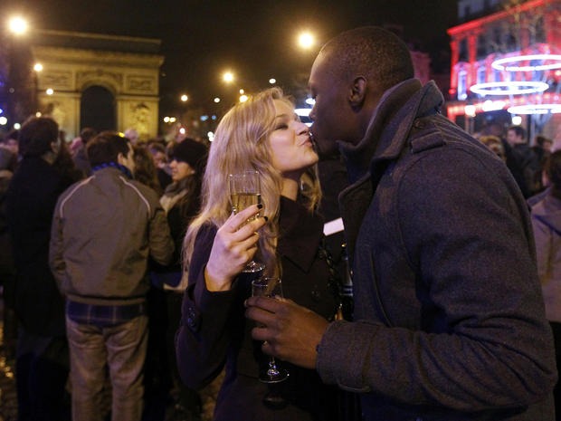 Revelers celebrate New Year's Day on the Champs Elysees in Paris Jan. 1, 2012, with the Arc de Triomphe in the background. 