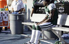 New York Jets wide receiver Santonio Holmes (10) sits alone on the bench in the closing minutes of an NFL football game against the Miami Dolphins, Jan. 1, 2012, in Miami.  