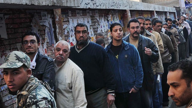 Egyptians stand in line waiting to cast their votes 