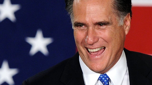 Republican presidential hopeful Mitt Romney smiles as he arrives to speak at his caucus night rally following Republican caucuses in Des Moines, Iowa, Jan. 3, 2012. 