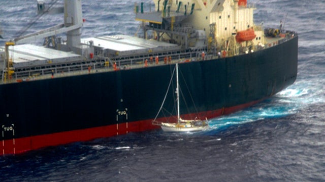 Japanese merchant ship White Kingdom, top, approaches the 32-foot sailboat of U.S. sailor Thomas Louis Corogin to rescue him in the Pacific Ocean south of Easter Island, Chile, Jan. 4, 2012, in this photo released by the Chilean navy. The 84-year-old Amer 