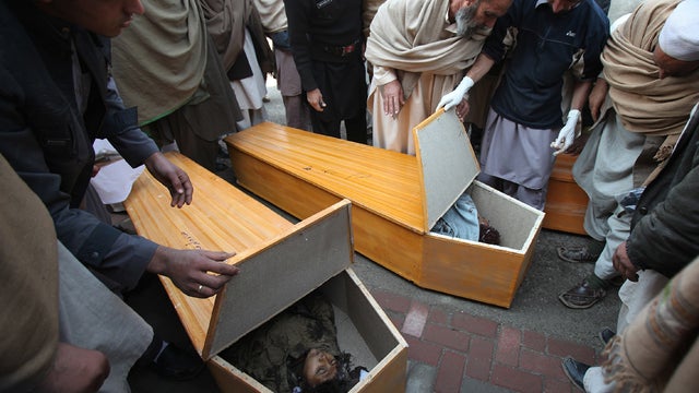 People look at bomb victims at a hospital in Peshawar 