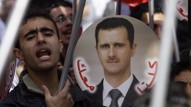 Syrian supporters of President Bashar Assad at a rally 