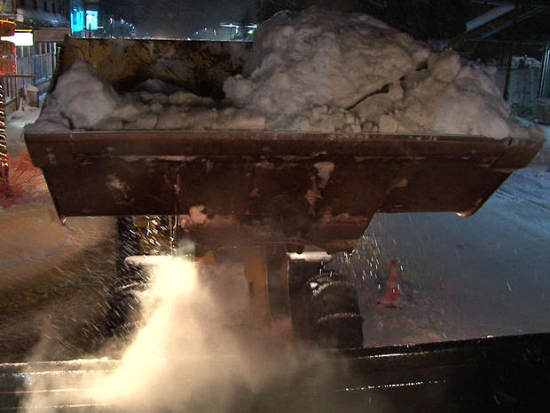 Heavy digging equipment is used to move tons of snow clogging the roads of Cordova 