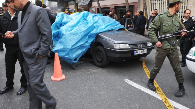Iranian security forces stand guard around the site of an explosion 