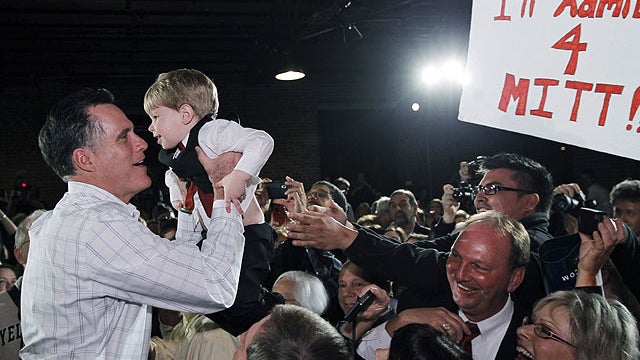 Republican presidential candidate, former Massachusetts Gov. Mitt Romney, picks up a child as he campaigns at The Hall at Senate&acirc;??s End, in Columbia, S.C., Jan. 11, 2012.  