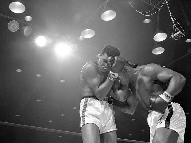 Sonny Liston lowers his head and works in close against Muhammad Ali 