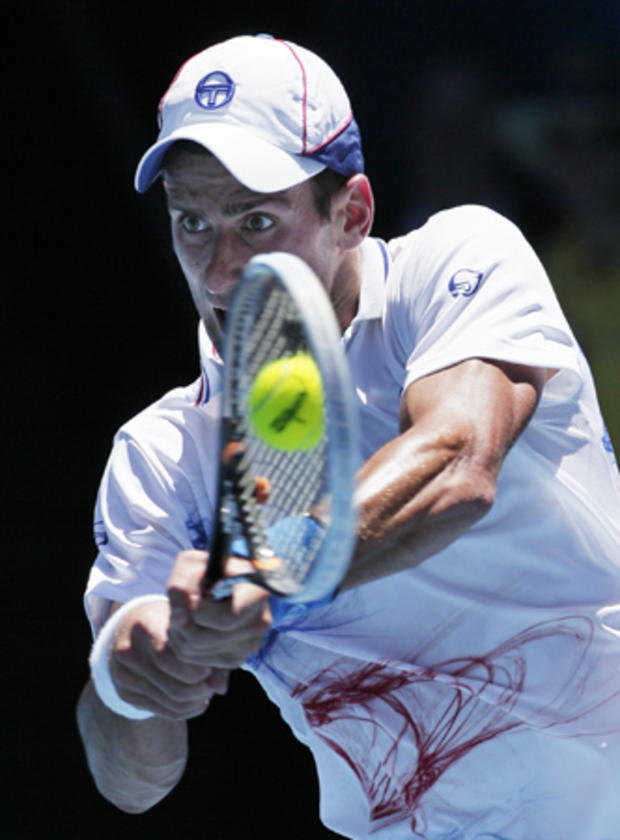 Novak Djokovic makes a backhand return 