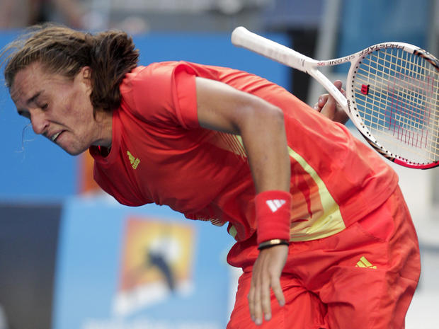 Alexandr Dolgopolov tries to catch a racket 