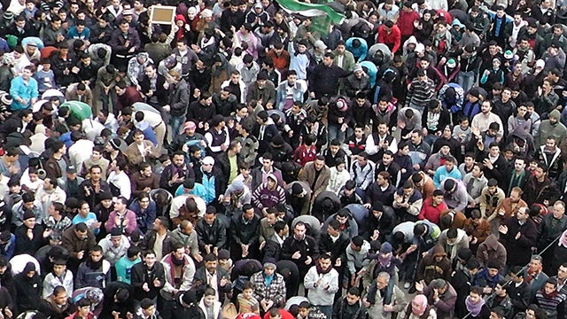 Syrian anti-regime demonstrators gather in the Khalidiya neighborhood said to be under the control of the Free Syrian Army in the flashpoint city of Homs, Syria, Jan. 20, 2012. 