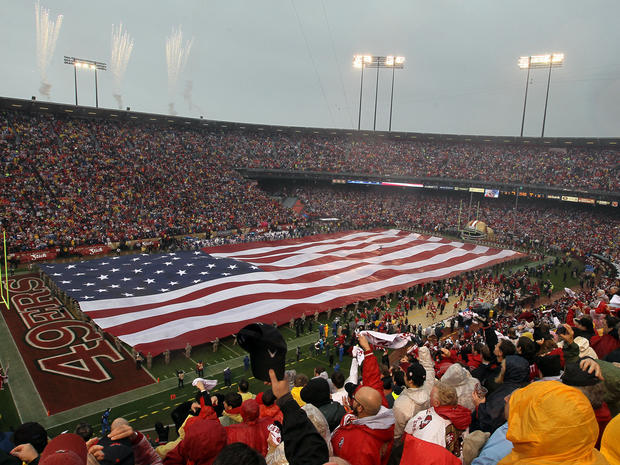 An American flag is opened on the field before the start of the NFC Championship Game  