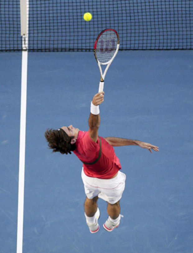 Roger Federer  leaps for a smash 