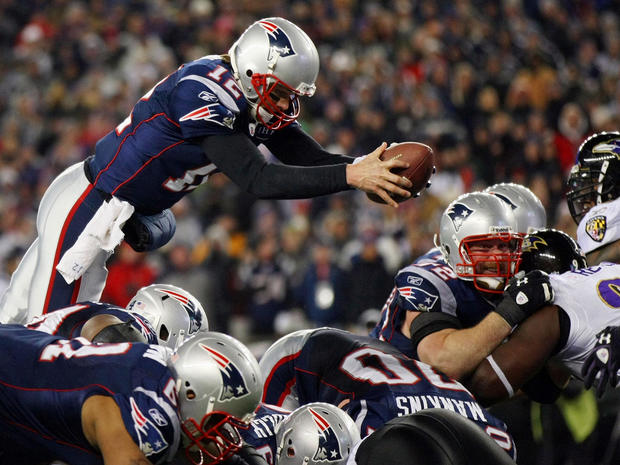 Tom Brady dives into the end zone to score a touchdown  