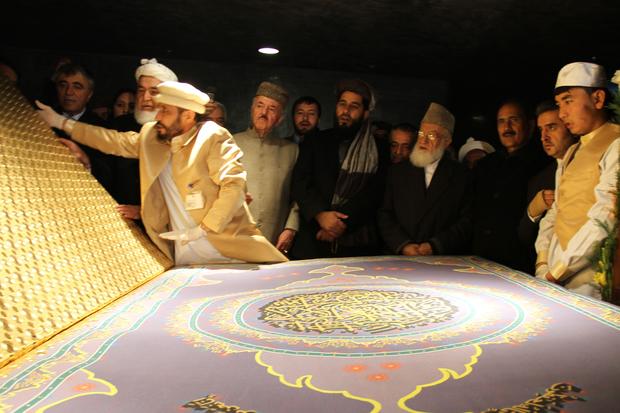 Calligrapher Mohammed Sabeer Hussani carefully opens the Quran 