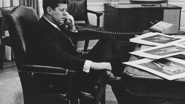 President John F. Kennedy is shown as he ends his official day after 7:30 pm with a final phone call 