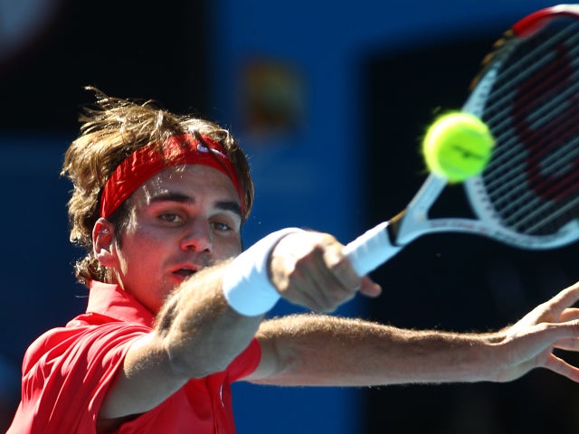 Roger Federer makes a backhand return  