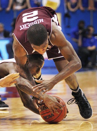 Tyshawn Taylor and Naji Hibbert scramble for the ball  