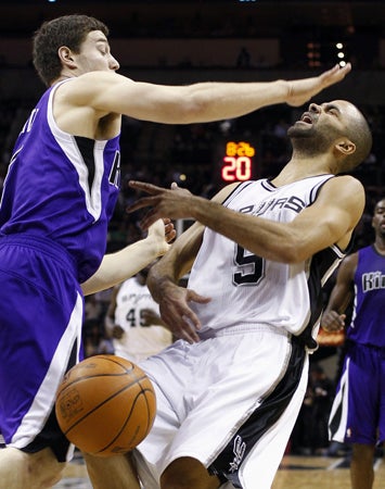 Tony Parker  is fouled by Jimmer Fredette 