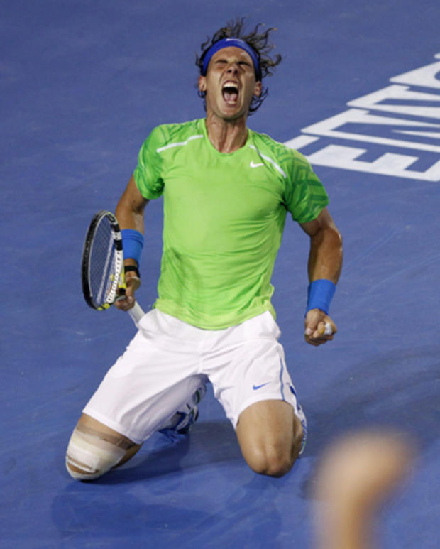 Rafael Nadal celebrates winning the fourth set against Novak Djokovic 