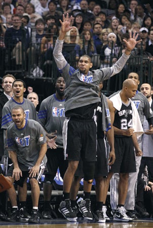 Tim Duncan raises his armsin celebration 