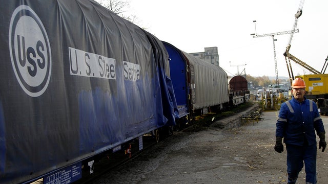 A worker passes by a U.S. Steel rail wagon in the city of Smederevo, Serbia, Nov. 11, 2011. Serbia's government has agreed to buy from U.S. Steel its loss-making plant in the Balkan country for a symbolic $1 with a goal to avoid its closure and the layoff 