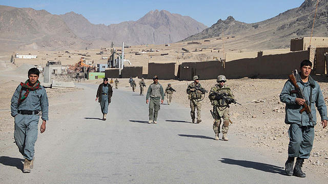 Afghan policemen walk ahead of the U.S. soldiers with the NATO- led International Security Assistance Force (ISAF) during a foot patrol in Kandahar, south of Kabul, Afghanistan, in this Jan. 7, 2012 file photo.  