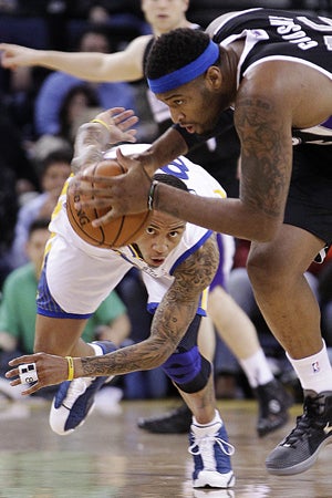 DeMarcus Cousins takes control of the ball fromMonta Ellis  