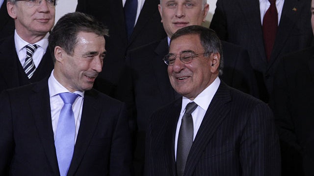 NATO Secretary General Anders Fogh Rasmussen, bottom left, speaks with United States Secretary of Defense Leon Panetta, bottom right, during a group photo of NATO defense ministers at NATO headquarters in Brussels on Feb. 2, 2012.  