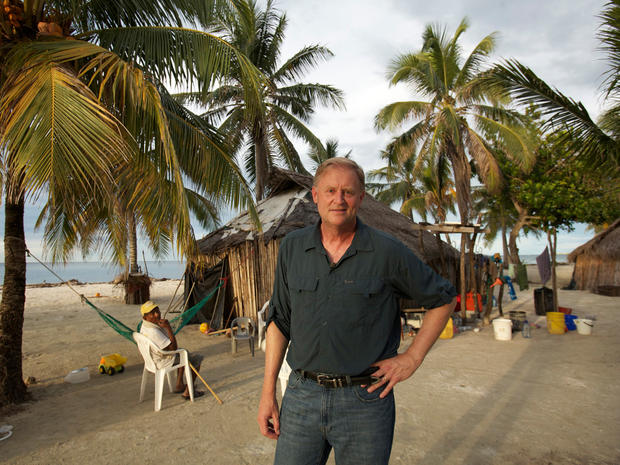 Correspondent Peter Van Sant in front of Kuna huts on Chichime. 