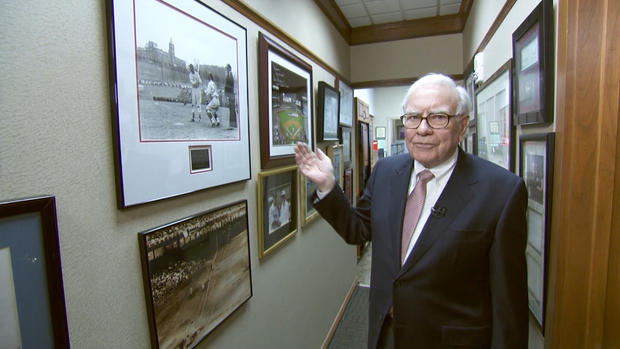 Warren Buffett has several prized photos of his hero Ted Williams lining his office hallway  