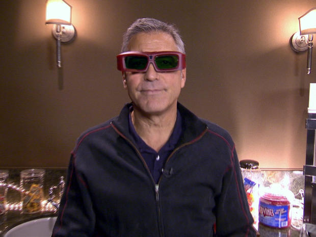 George Clooney ties on 3D glasses durign his "Person to Person" tour of his L.A. home 